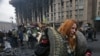 UKRAINE -- A file picture made available 22 November 2014 shows a young Ukrainian woman carrying tires, helping to build a new barricade on Independence Square in Kiev, Ukraine, 20 February 2014