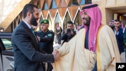 Səudiyyə Ərəbistanının vəliəhd şahzadəsi Məhəmməd bin Salman Ər-Riyaddakı kral sarayında Suriyanın müvəqqəti prezidenti Əhməd əş-Şaraa ilə salamlaşır.